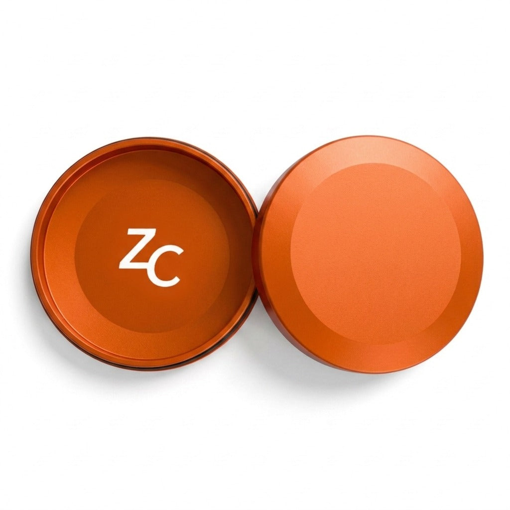 Z Caddy metal pouch can in orange, lid and base shown separated from above